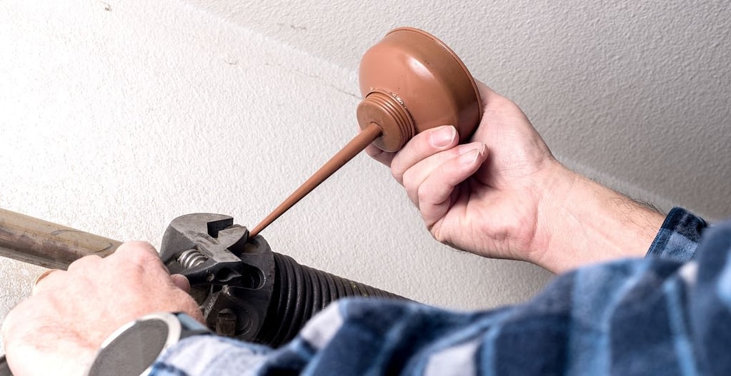 Preventative maintenance is being done by a handyman on the spring