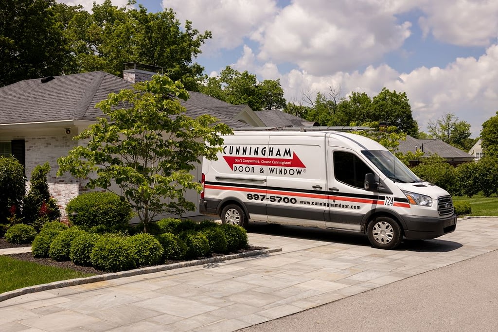 garage door cable replacement Cunningham van parked outside big american house