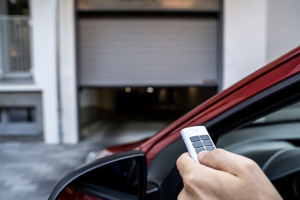 Automatic Wireless Home Garage Door. Hand Using Controller