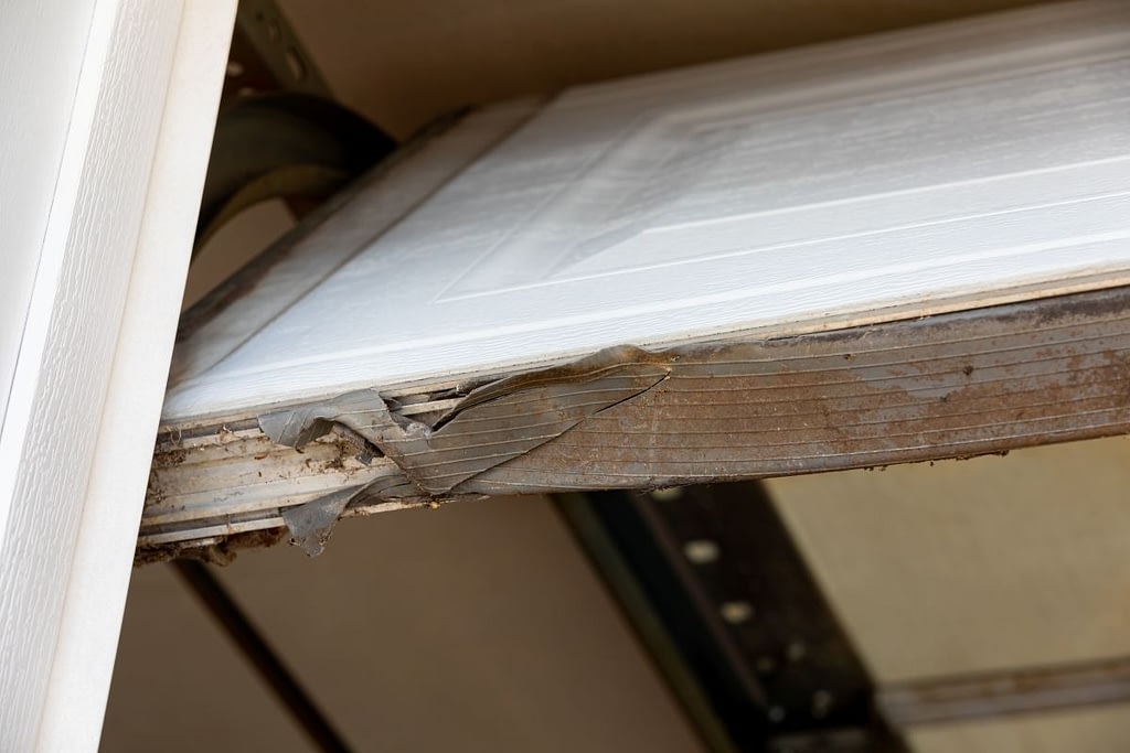 Overhead garage door weather stripping seal torn and broken
