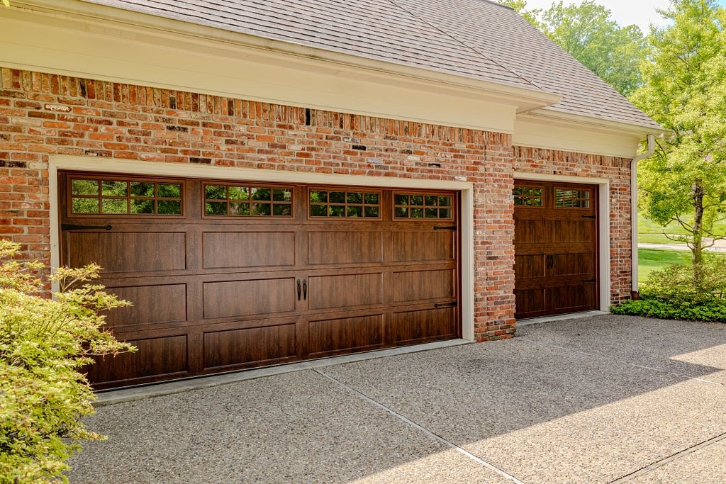Wooden garage door on a brick house