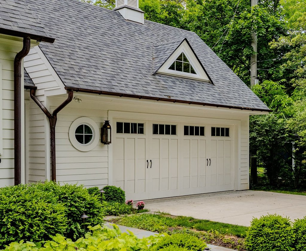 white garage doors on a white house