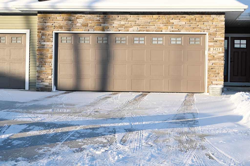 brown garage door in the snow