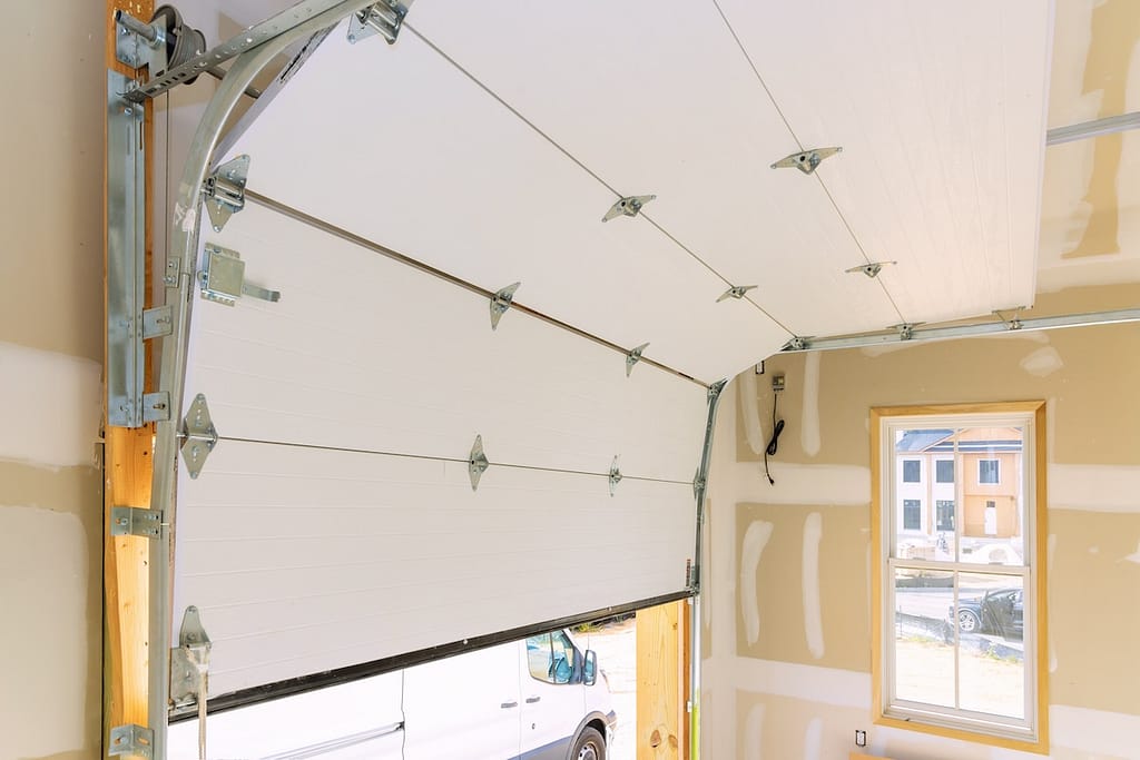 In construction of new home, rolling shutters plastic garage doors were installed