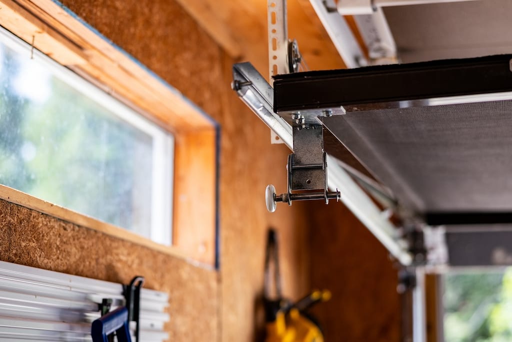 Garage door track door