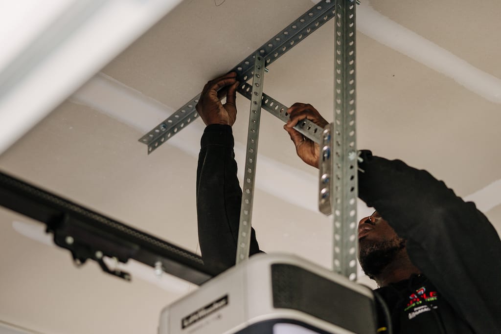 Apple door worker fixing garage door opener