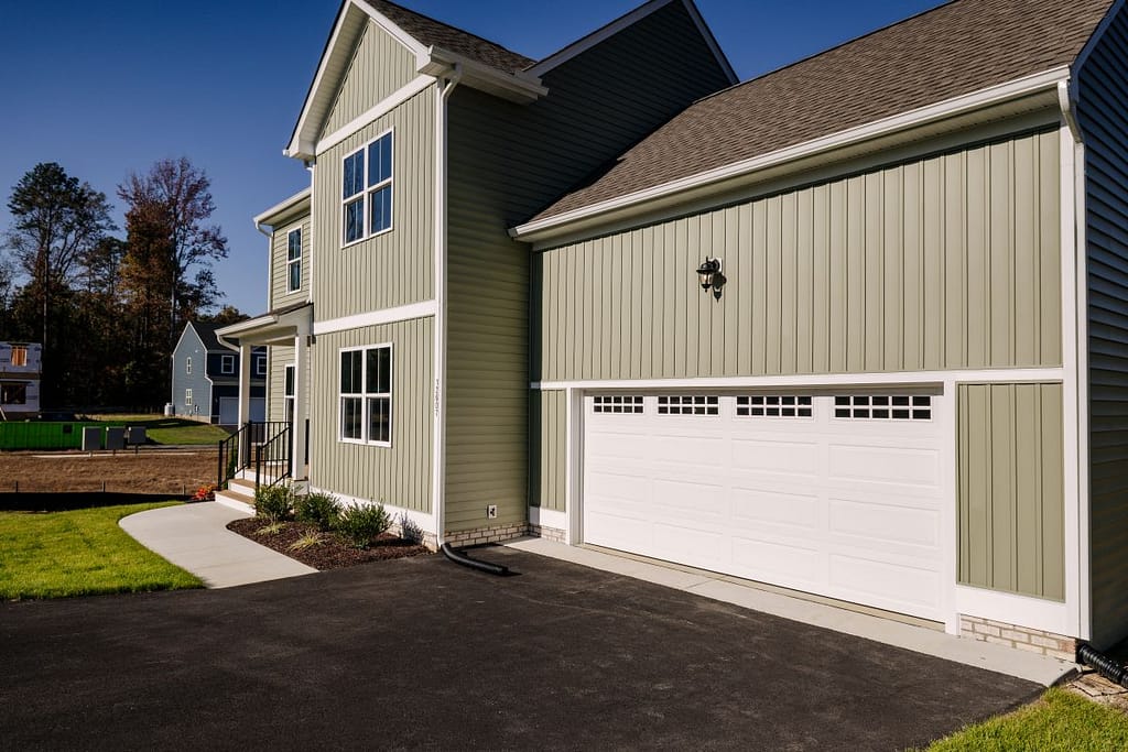 A house with a white garage door with windows