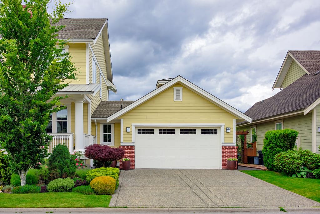 yellow house with a white double garage door