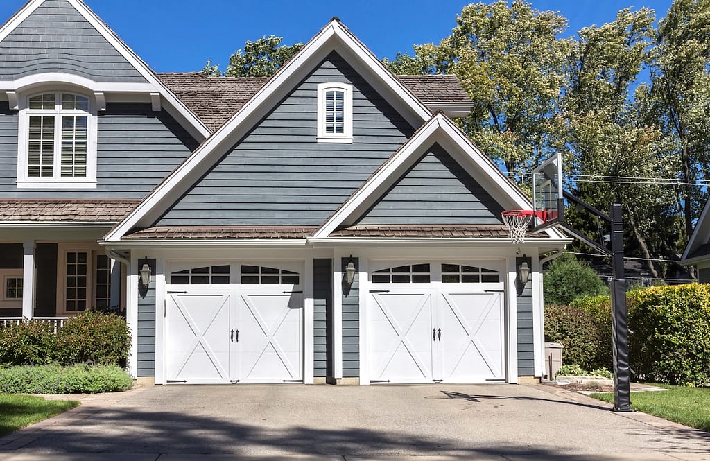 Traditional four car wooden garage with driveway