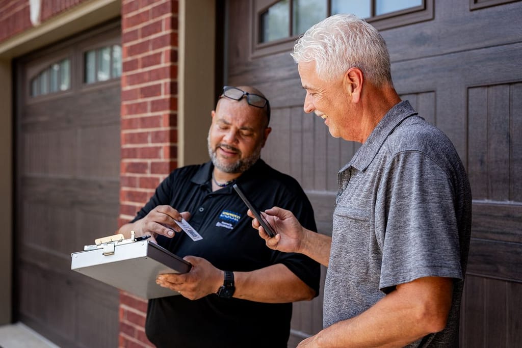 garage door opener installation Cheney Door technician closing deal with client