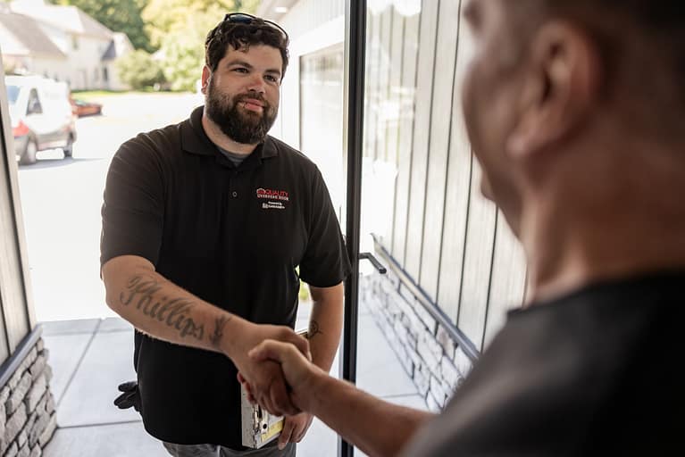 quality overhead door employee shaking customer's hand