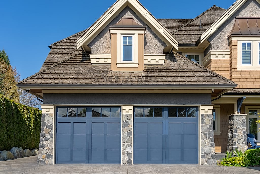 Garage door in luxury house with trees and nice landscape