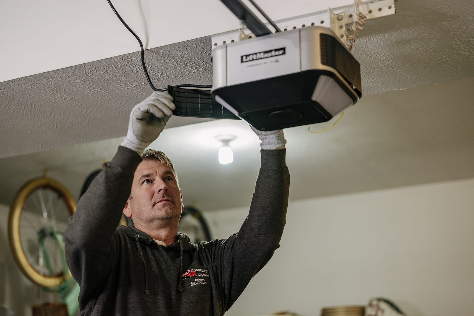 man servicing a garage door opener