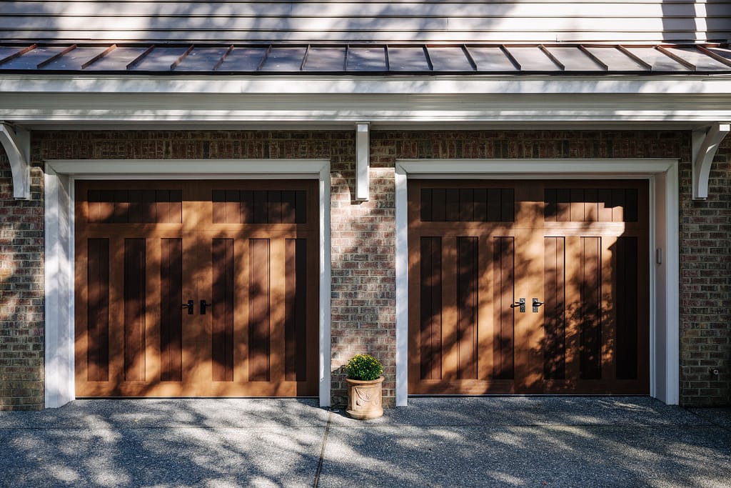 wood 2-door garage with small roof overhang