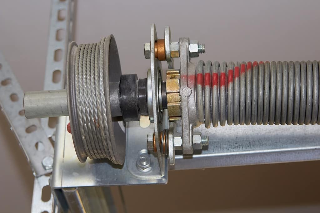 garage door mechanism with roller and cable and spring