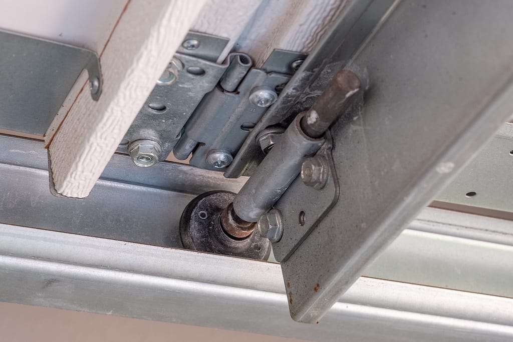 Close up of Single Roller and Hinge in a Garage Door Track