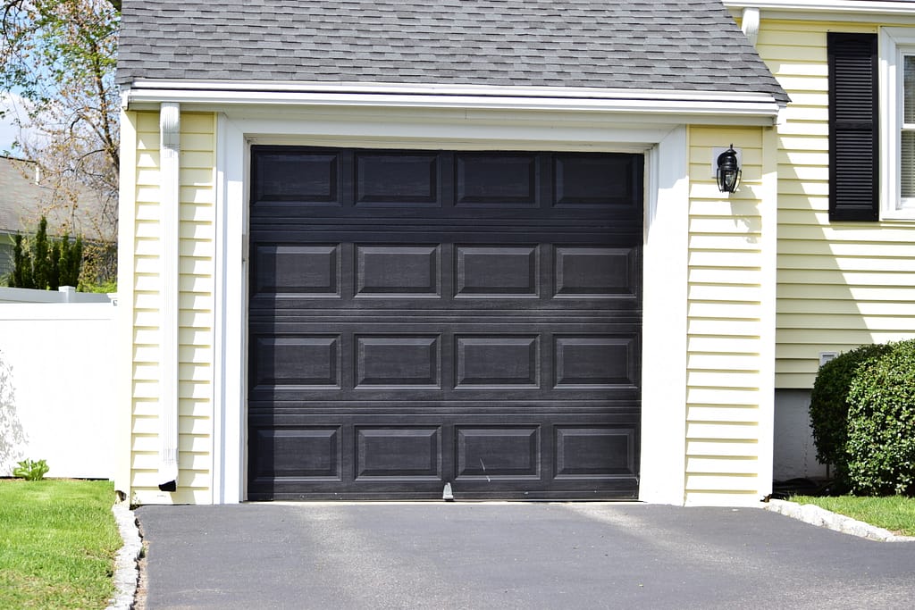 Black door on pastel yellow house