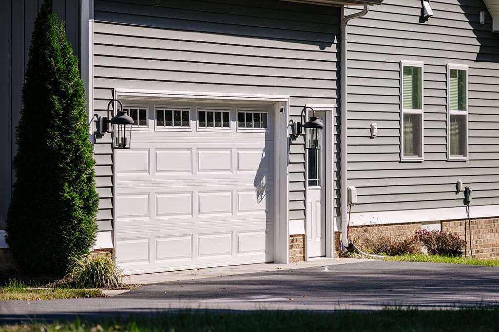 single garage door on grey house