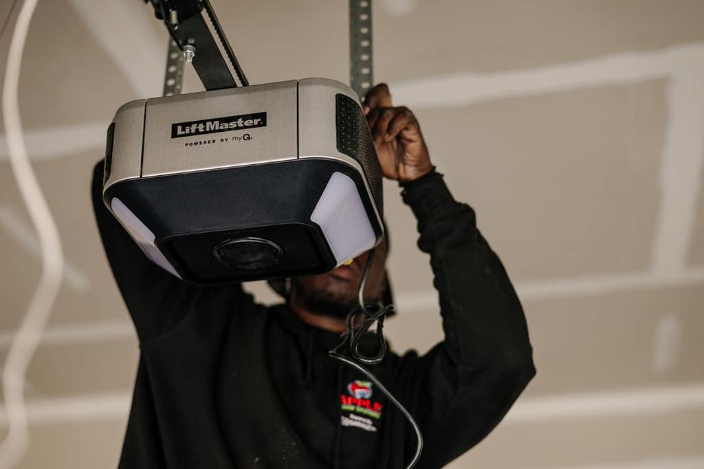 Apple Doors team member fixing a garage door opener