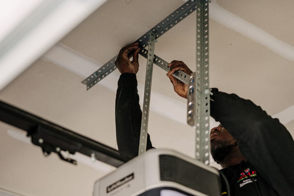 Apple team member fixing a garage door opener