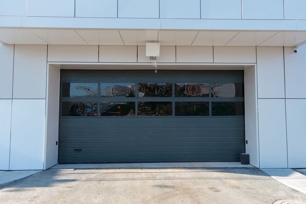 Modern commercial garage door with large glass panels