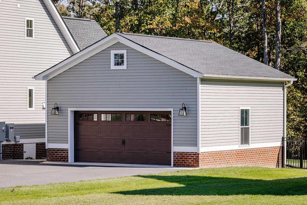 front door with glass panels small garage with shingles roof